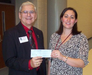 Watkins (l) presents Heather Connelly, Stall High School, with a $1,000 grant in December to help her school procure a Vernier LabQuest and probes.